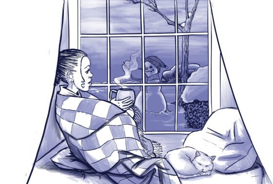 A girl is wrapped up in a blanket looking at a window at a snowman